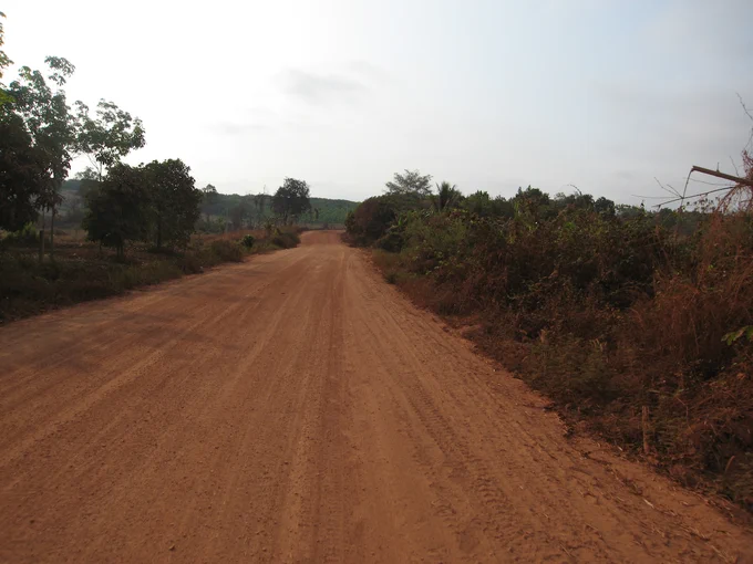 2015 photograph by the author of the article of a newly created red earth road in Mondulkiri province, northeastern Cambodia.