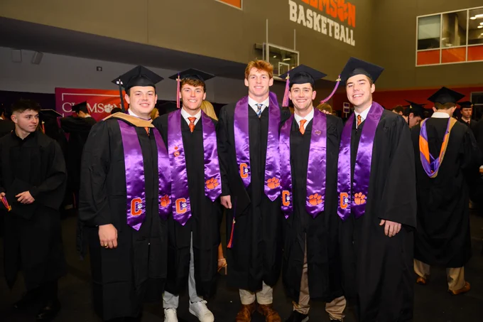 A group of students posing for a photo at graduation.