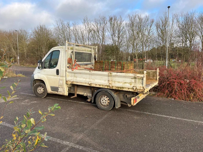 Overweight light goods vehicle carrying sand and bricks. No tailboard fitted which is not road safe compliant to ensure the load does not fall out.