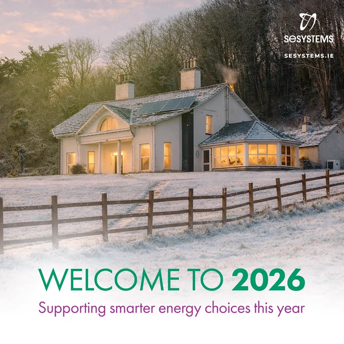 Snow-covered countryside home with solar panels on the roof and warm lights glowing inside. Text overlay reads Welcome to 2026 and Supporting smarter energy choices this year, with SE Systems branding visible.