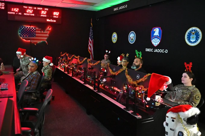 soldiers and civilians track santa on screens