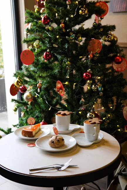 Festive cafe table with treats by a Christmas tree, perfect for holiday ambience.
