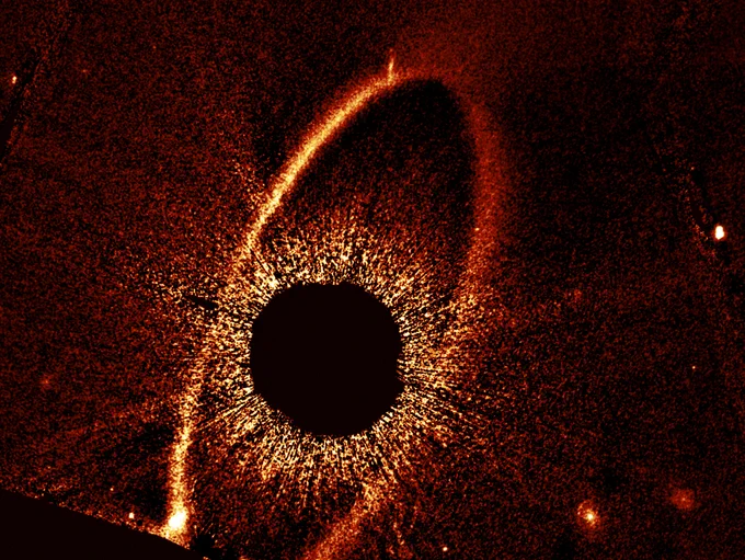 This composite NASA/ESA Hubble Space Telescope image shows the debris ring and dust clouds cs1 and cs2 around the star Fomalhaut.