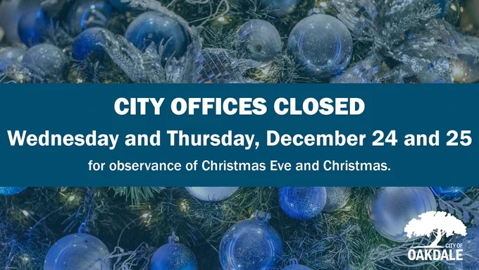 graphic with  image of christmas tree with silver and blue ornaments and silver garland and bows with blue overlay with blue band across the middle and white text that reads "CITY OFFICES CLOSED Wednesday and Thursday, December 24 and 25 for observance of Christmas Eve and Christmas." and white logo in bottom right with white tree and text that reads "CITY OF OAKDALE"