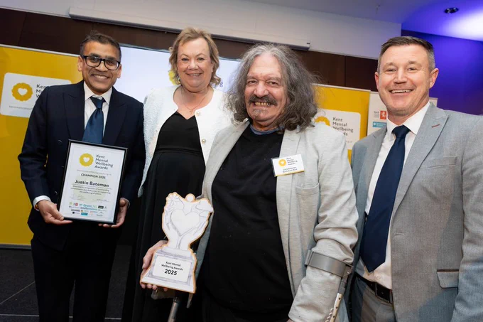 Justin Bateman is holding his trophy and stood with Dr Kush Kanodia, Kent Community Foundation's Catherine Glover and Southeastern's Lee Woolcott-Ellis