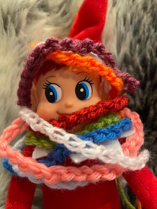 Evie the Christmas elf wearing 10 scarves indoors because it’s cold 