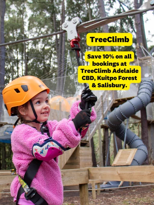 Child in safety gear participating in a ropes course at TreeClimb Adelaide, surrounded by trees. Text overlay offers a 10% discount at TreeClimb locations in Adelaide CBD, Kuitpo Forest, and Salisbury.