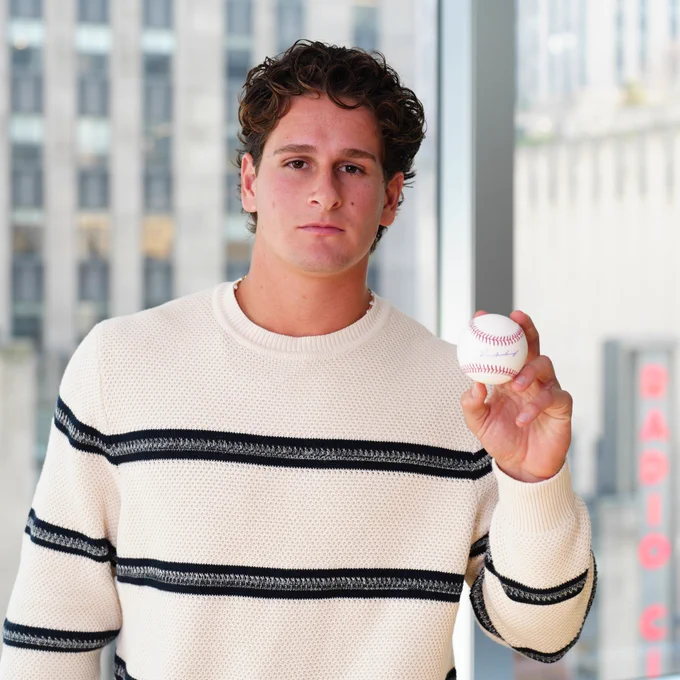 Roman Anthony holds the baseball he autographed for this giveaway (Photo: Gabriella Ricciardi/Major League Baseball)