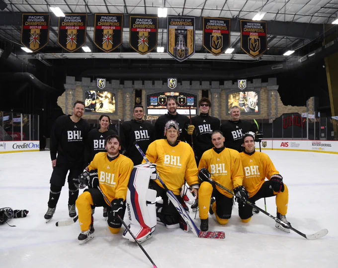 Group photo of the Americans  in front of the scoreboard at city national arena