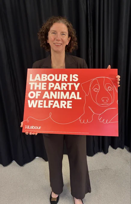 Anneliese stood holding a sign saying “Labour is the party of animal welfare”