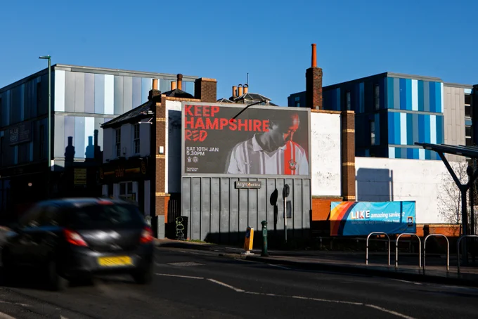 An image of Southampton FC Women's "Keep Hampshire Red" advert featuring Atlanta Primus on an electronic advertising board in Southampton's Bevois Valley area