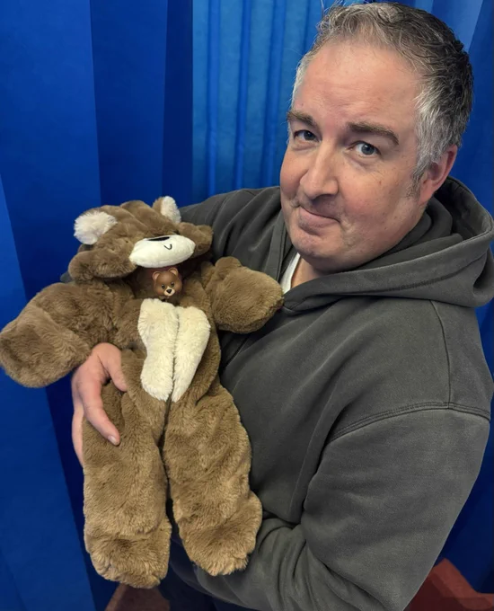Me holding my beautiful new granddaughter dressed in a bear onesie (what else 😂)