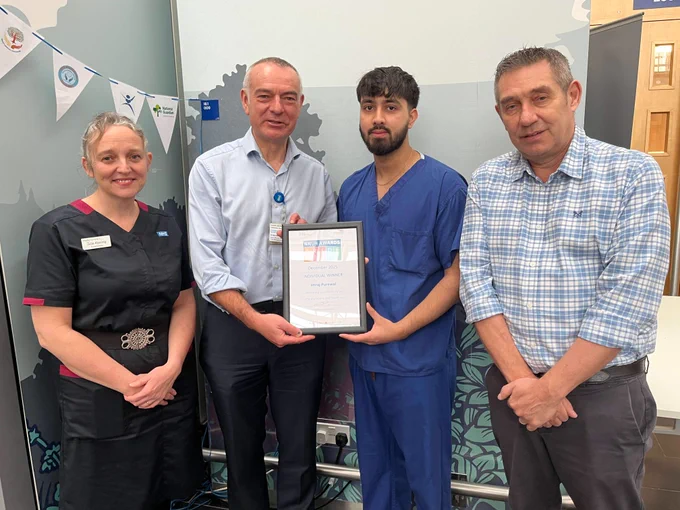 Imraj Purewal receiving his PRIDE award from Bernard Brett, Medical Director. They are standing with Chief Operating Officer Chris Cobb and Nurse Director Julie Keeling.