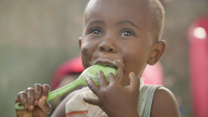 Child eating porridge in the Republic of Congo