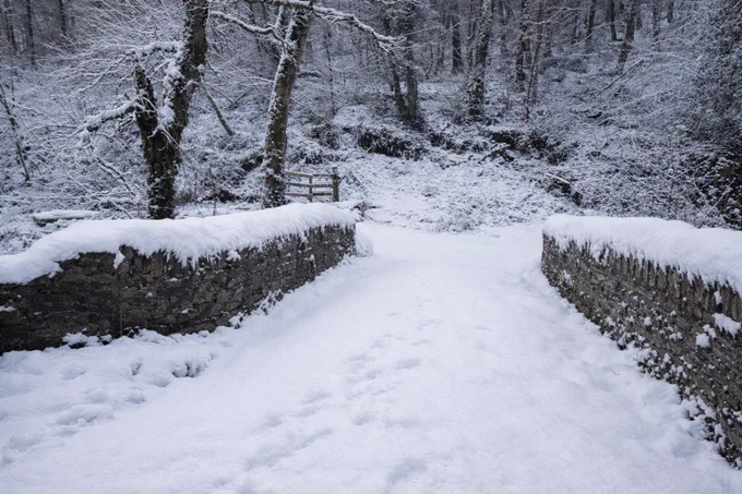 A snow covered road and bridge near Newcastle Emlyn, West Wales, blanketed in fresh snow following heavy January snowfall in 2026.