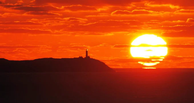 WOWW!! . A stunning ‘Omega sunrise’ forms beside the Old Head of Kinsale Lighthouse (with the first rays of sunlight reflecting off the lantern of the lighthouse too..) in West Cork , Ireland!!