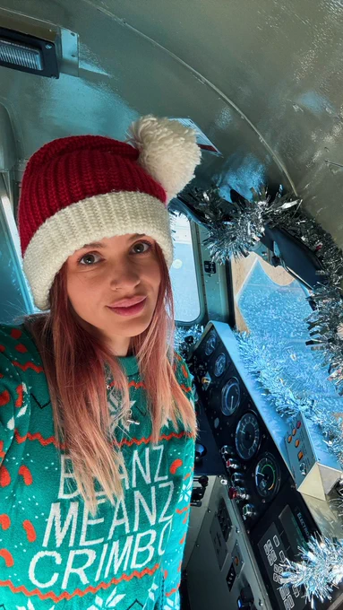 I’m wearing a Father Christmas hat and an awful bean Christmas jumper. I’m stood in the cab of 69008 which has been tinselled!