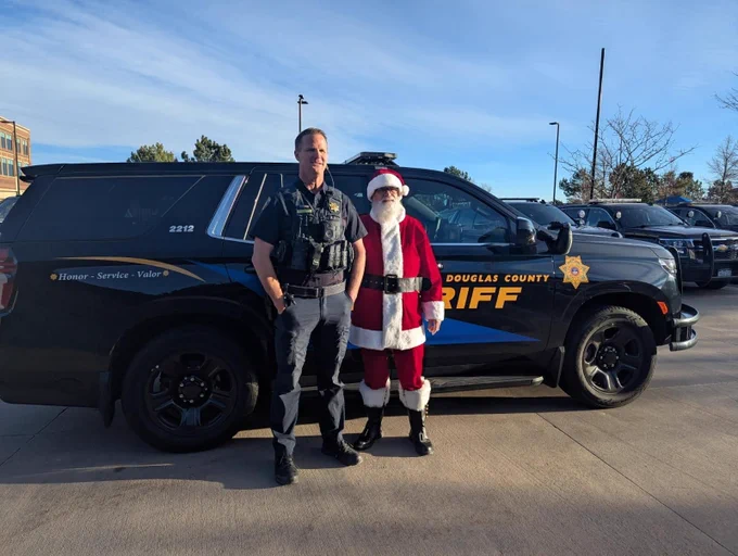 Deputy with Santa in front of patrol car