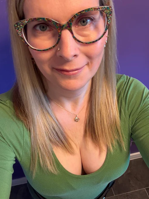 Just a picture of me in a green top with matching green glasses.