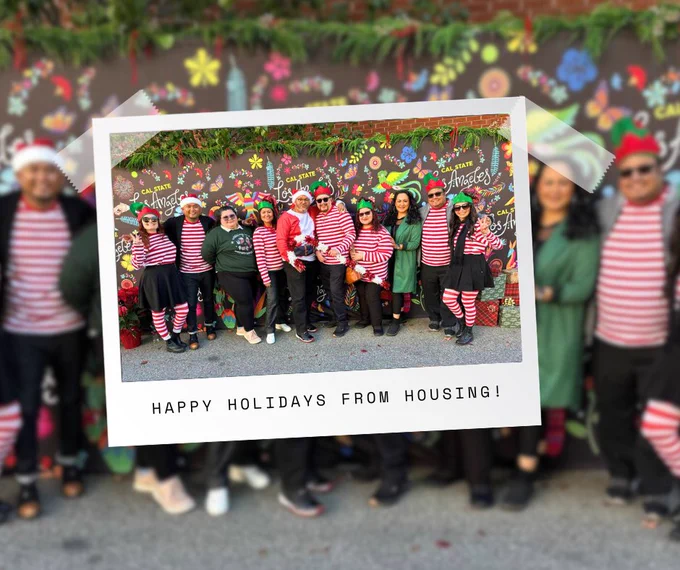 Housing staff pose together in festive holiday outfits in front of a colorful Cal State LA backdrop, with text reading “Happy Holidays from Housing!” 