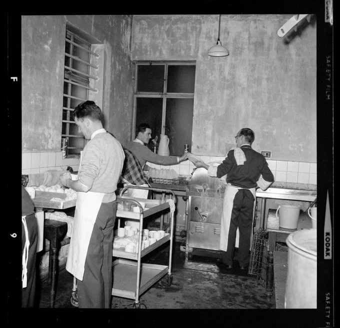 Black and white photo of three Jesuits washing up