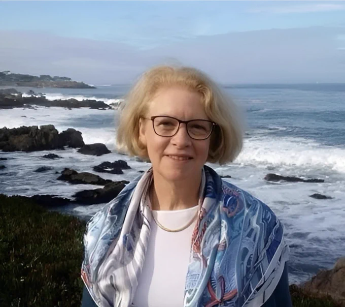 A photo of Kristina Gjerde in front of a rocky beach.