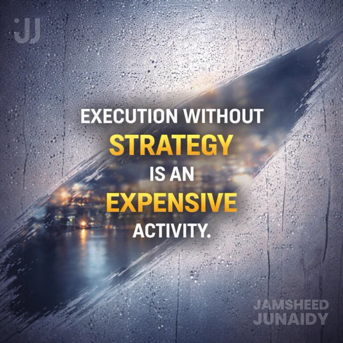 A conceptual business and marketing visual featuring bold text that reads “Execution without strategy is an expensive activity,” with the words “strategy” and “expensive” highlighted in yellow. The background shows a rain-covered glass surface with blurred city lights visible through a clear diagonal path, symbolising clarity cutting through confusion. The image represents the cost of executing marketing without a clear strategy, planning or direction. Branding elements include the name Jamsheed Junaidy, founder of Firstclusive, a leading branding and marketing agency based in Hyderabad that helps businesses grow through strategy-first marketing, clarity and structured execution.