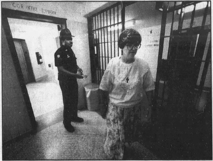 Clipping from 1993 newspaper showing Sister Helen Prejean entering a row of cells at Angola Louisiana State Penitentiary, followed by a correctional officer. 