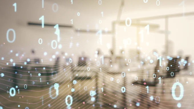 Digital binary code overlaid on a blurred background featuring wind turbines, illustrating a concept of sustainable technology or green energy.