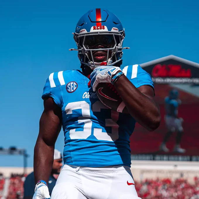 Ole Miss Rebels freshman running back Shekai Mills-Knight carries the ball in his left arm ahead of a college football game.