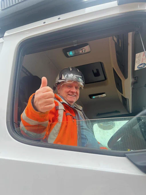 One of our gritter drivers smiling and thumbs up in a gritter