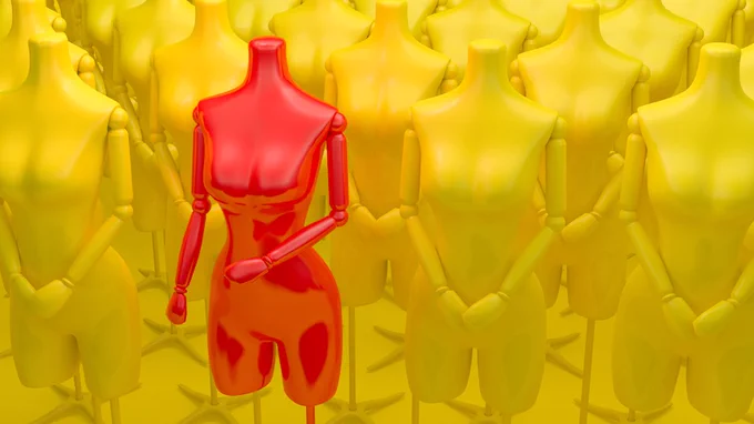 Red mannequin stands out among multiple yellow mannequins.