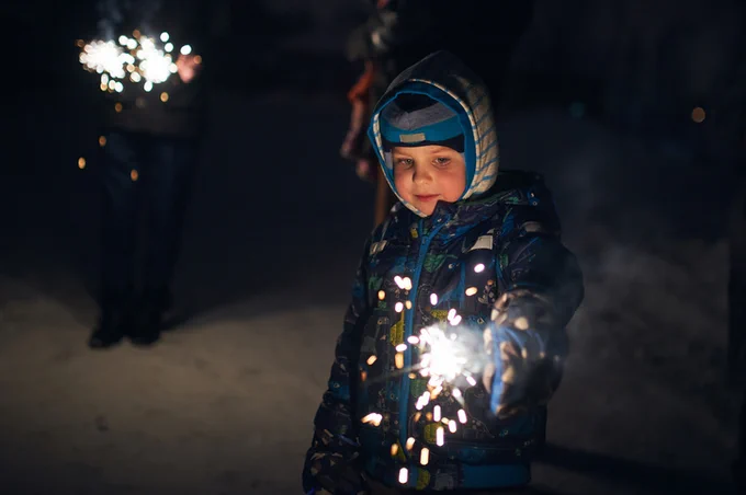 An image of a child playing with sparklers
