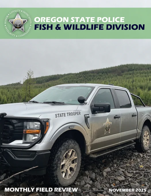 A silver OSP Fish and Wildlife patrol truck sits on gravel with a tree covered mountain in the background.