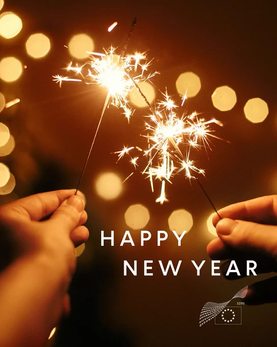 Two hands holding lit sparklers against a warm, festive background, with the text ‘Happy New Year’