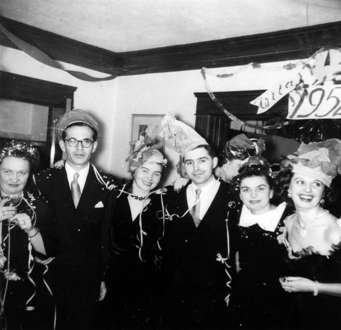 Six people pose for a photo while attending a house party on New Year's Eve.