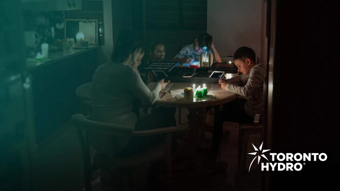 A family around a table with candles.