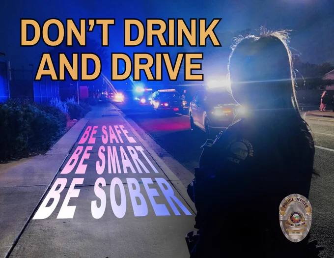 officer at night with police lights and words that say don't drink and drive