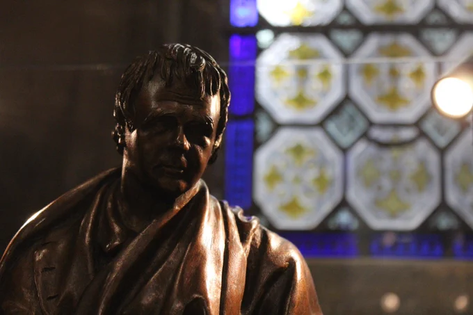 Statue of Sir Walter Scott inside Scott Monument.  Stained Glass window behind