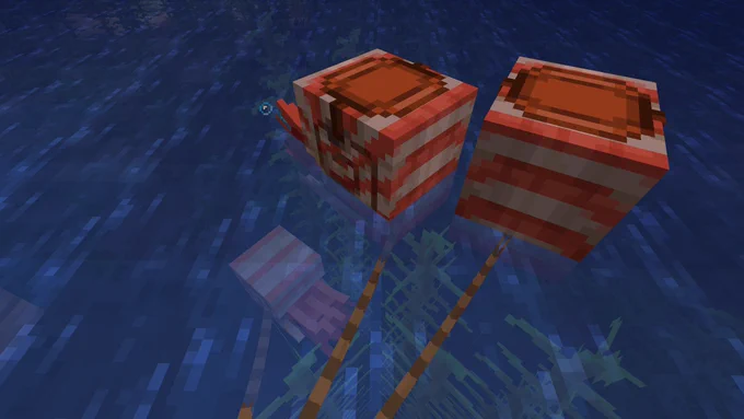 Two adult Minecraft nautilus and a baby nautilus on leads in the ocean