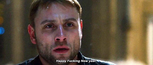 A man with a beard, looking beaten up, and standing in front of snowfall, says happy fucking new year. This is Wolfgang from sense8.