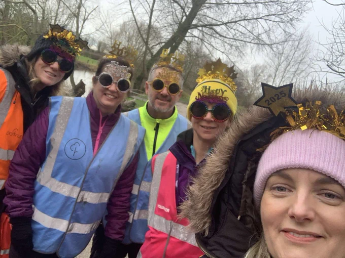 Image of group of parkrunners wearing New Years glasses and hats