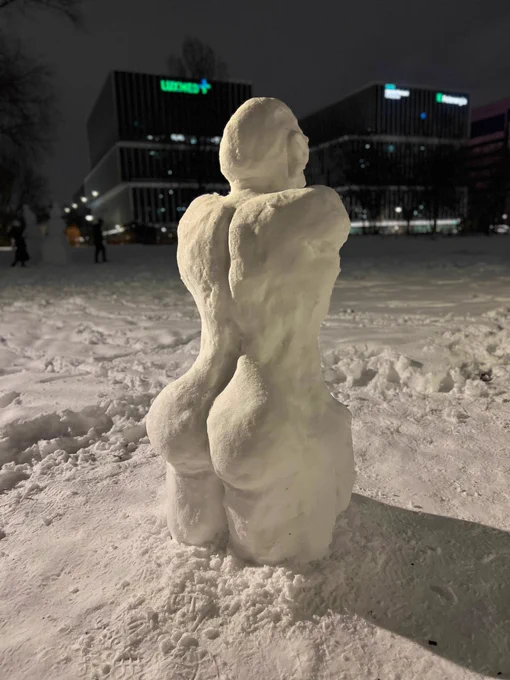 an almost anatomically correct snowman with a big butt, viewed from behind