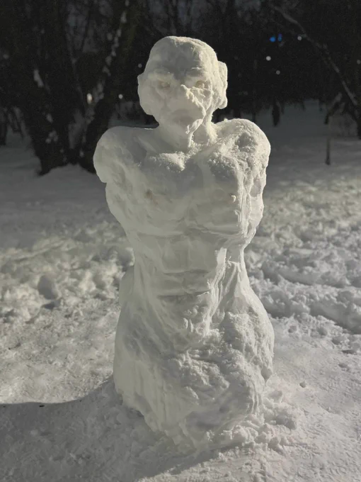 an almost anatomically correct snowman resembling a muscular man with a big nose and a moustache