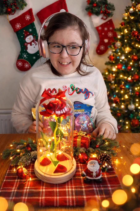 Girl smiling in front of eternal rose light