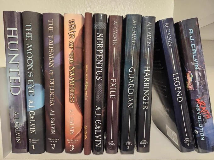 AJ Calvin's books, spine facing forward.
From Left to Right:
Hunted, The Moon's Eye, The Talisman of Delucha, War of the Nameless, The Ballad of Alchemy and Steel, Serpentus, Exile, Guardian, Harbinger, Legend, Wraith and the Revolution
