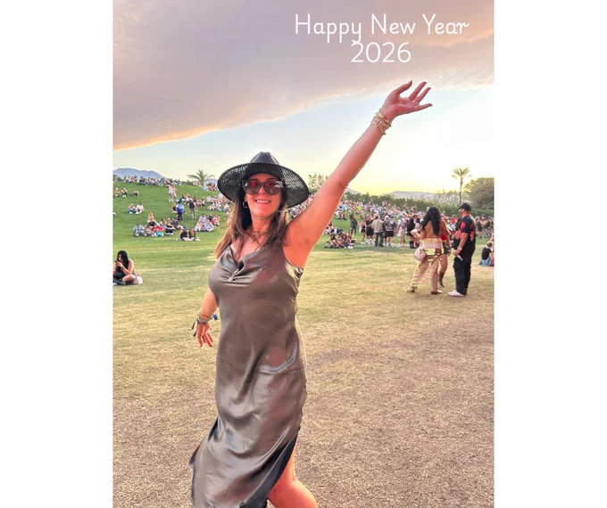 A girl appearing to touch a cloud in the sky at Coachella Music Festival, Indio, California, 2025.
