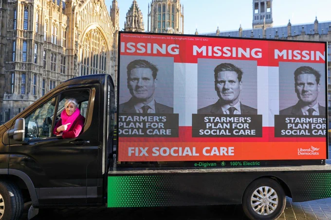 IMAGE: Lib Dem Deputy Leader Daisy Cooper MP Driving the ad van that says: MISSING, STARMER'S PLAN FOR SOCIAL CARE, FIX SOCIAL CARE. 