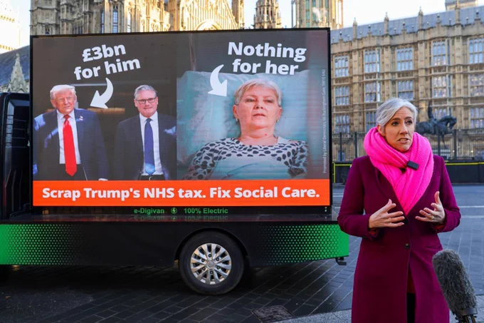 IMAGE: Lib Dem Deputy Leader Daisy Cooper MP

Standing infront of an ad van which says: ''Scrap Trump's NHS tax. Fix Social Care'' 

