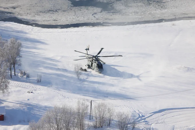 A Merlin helicopter lands in the Arctic